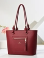 Deep burgundy textured leather tote bag with unique knotted rope handles and gold zipper detail - Wine Red