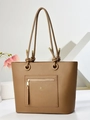 Macro detail of brown pebbled leather texture with gold zipper and branded metal logo - Khaki