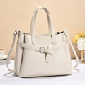 Detail of cream white pebbled leather tote bag with silver hardware on elegant background - Medium / Off-white