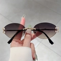 Detail view of rimless oval sunglasses with brown gradient lenses and gold metal frames - Gold Frame Gray Brown Lens