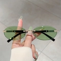 Vue détaillée de lunettes de soleil ovales sans monture, verres verts et pont doré - Monture Or Vert