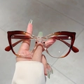 Retro cat-eye blue light blocking glasses with brown gradient frames held by hand - Champagne Gradient Tea Frame Transparent Lens