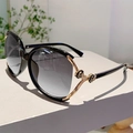 Detailed view of black oversized sunglasses with a gold rose carving on the temple hinge - Black Frame Gradient Grey