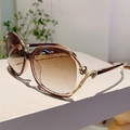 Detail of elegant gold rose carving on sunglasses temple with gradient brown lenses - Tea Frame Gradient Tea