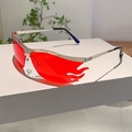 Fashion rimless flame shaped sunglasses with red lenses and silver metal frame on a display - Silver Frame Red Lens