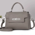Close-up of grey-purple lychee grain leather handbag with silver chain buckle detail - Gray