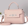 Detail of pink lychee leather handbag with silver chain lock and removable strap - Pink