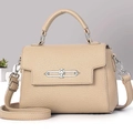 Detail of beige pebble leather crossbody bag featuring silver geometric metal clasp lock - Khaki