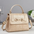 Detail of beige crocodile pattern handbag with gold horsebit buckle and curved handle - Khaki