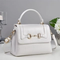 Close-up of white embossed leather handbag with gold horsebit buckle and top handle - Off-white