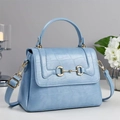 Detail of light blue croc-embossed leather handbag with gold horsebit buckle and handle - Blue