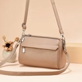 Close-up of litchi texture leather shoulder bag with silver zipper and front flap pocket - 24x12x17cm / Khaki