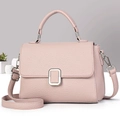 Detailed close-up of pink lychee grain leather crossbody bag with silver buckle - Pink