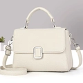 Close-up of beige lychee texture leather bag with elegant silver metallic buckle detail - Off-white
