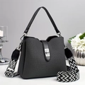 Detailed view of gray bucket bag with woven texture and stylish geometric wide strap - Black