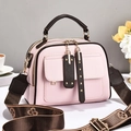 Pink lychee grain leather handbag with brown handles and a patterned wide strap - Pink