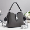 Detailed view of grey woven bucket bag with stylish geometric pattern wide fabric strap - Gray