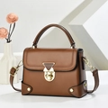 Retro brown crossbody bag with gold triangle lock and decorative stitching detail - Brown