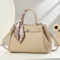 Elegant beige leather handbag with scarf detail and silver twist lock in a front view - Khaki