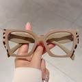Fluorescent polygonal blue light glasses with leopard print and pink frame held by hand - Khaki Leopard Frame Transparent Lens