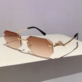 Macro view of rimless gradient sunglasses with gold metal hinges and leopard head embossing - Brown