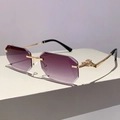 Detailed close-up of leopard head gold hardware on purple gradient rimless sunglasses - Gradient Grey