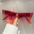 Fashionable oversized square sunglasses with pink-orange gradient lenses in hand - Purple Orange Frame Purple Lens