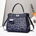 Blue leopard print patent leather handbag with silver turn-lock and matching mini charm - Blue
