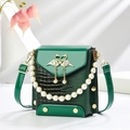 Emerald green crocodile pattern mini crossbody bag with pearl handle and swan buckle - Green