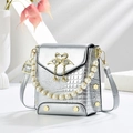 Silver crocodile texture crossbody bag with pearl handle and golden swan buckle accent - Silver
