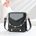 Detail of crocodile embossed leather texture and silver chain on black crossbody bag - Black