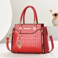 Glossy red crocodile embossed handbag with gold hardware and pearl leaf charm - L24 H19 W12 / Burgundy