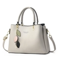 Elegant beige leather handbag with leaf charm and detachable strap for daily commuting - Gray