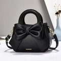 Sac à main chic noir avec grand nœud, détails dorés et bandoulière réglable - Noir