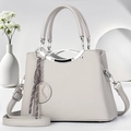 Sac à main élégant en cuir gris avec poignées rondes et pendentif tressé pour femme - Gris