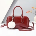 Elegant deep red Boston handbag in glossy leather with a fluffy white charm - Red