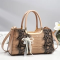Detail of beige snakeskin textured handbag with pearl bow pendant and lace trim - Khaki