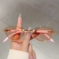 Retro sunglasses with gold metal frames and pink translucent lenses in a stylish hand view - Gold Frame Pink Lens Light Pink Temples