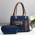 Close-up of navy snakeskin pattern tote with brown straps and golden metal zippers - Blue