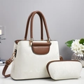 Detail of white textured leather tote bag set with brown handles and gold hardware accents - Off-white