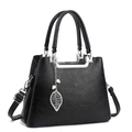 Detail of black pebbled leather handbag with silver hardware and leaf pearl charm - Black