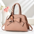 Detail of dusty rose litchi grain handbag with a silk scarf wrapped around handle - Pink