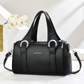 Black pebble leather cylinder handbag with large silver ring handles and shoulder strap - Black
