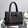 Fashionable black bow handbag with geometric wide shoulder strap and woven tassel charm - Black