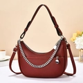 Close-up of burgundy leather hobo bag with silver chain detail and adjustable strap - Burgundy