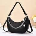 Detail of black hobo bag with pebble leather texture, silver chain and double straps - Black