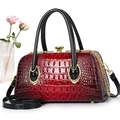 Detail of red crocodile embossed handbag with crystal lock and golden hardware - Red