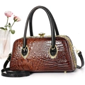 Close-up of brown crocodile pattern handbag with gold clasp and sparkling diamond detail - Khaki/Earth Yellow