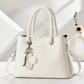 Elegant cream quilted handbag with clover charm and adjustable strap for women - Off White
