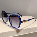 Detailed view of women's blue resin sunglasses with gold chain decorative temples - Transparent Blue Frame Grey Lens
